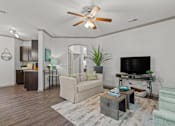 Thumbnail 2 of 59 - a living room with white walls and a ceiling fan at Stonepost Crossing Apartments, Overland Park, KS