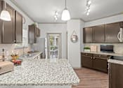 Thumbnail 9 of 59 - a kitchen with a large island in the middle of it at Stonepost Crossing Apartments, Overland Park, KS, 66213