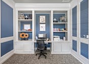 Thumbnail 58 of 60 - A room with a desk and a chair in front of a wall with shelves. at Crescent Apartment Homes, Kansas, 66219