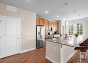 Thumbnail 18 of 50 - a kitchen with a large island and stainless steel appliances at The Dorset, Kansas City, 64112