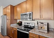 Thumbnail 6 of 50 - a kitchen with a stove top oven next to a refrigerator at The Dorset, Kansas City, 64112