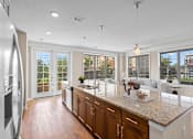 Thumbnail 2 of 50 - a kitchen with a large island next to a living room at The Dorset, Kansas City, MO