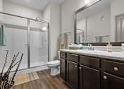 Thumbnail 21 of 59 - a bathroom with a toilet sink and shower at Stonepost Crossing Apartments, Overland Park, Kansas
