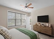 Thumbnail 17 of 50 - a bedroom with a large window and a ceiling fan at The Dorset, Kansas City, Missouri