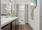 Thumbnail 20 of 59 - a bathroom with a toilet sink and shower at Stonepost Crossing Apartments, Kansas, 66213