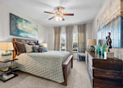 Thumbnail 13 of 59 - a bedroom with a bed and a ceiling fan at Stonepost Crossing Apartments, Kansas