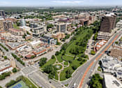 Thumbnail 39 of 50 - Aerial view of West Plaza neighborhood near The Dorset with shops, streets, and green space