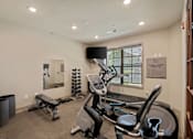 Thumbnail 37 of 50 - Fitness center at The Dorset with cardio machines, free weights, and workout bench