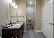 Thumbnail 42 of 50 - A bathroom with a sink, mirror, and towel rack.