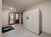 Thumbnail 41 of 50 - A white cabinet with a black handle is in a room with a black mat on the floor.