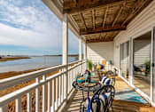 Thumbnail 6 of 11 - Private balcony with a table and chairs overlooking the Chesapeake Bay in Newport News, VA