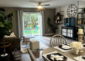 Thumbnail 3 of 14 - A dining room with a table set for a meal.