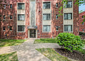 Thumbnail 2 of 27 - exterior view of a brick apartment building with sidewalks and grass