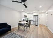Thumbnail 8 of 37 - a living room and kitchen with a table and chairs