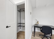 Thumbnail 18 of 37 - a room with a desk and a chair and a closet