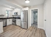 Thumbnail 16 of 27 - a renovated kitchen with stainless steel appliances and white cabinets
