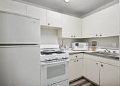 Thumbnail 27 of 37 - an empty kitchen with white appliances and white cabinets