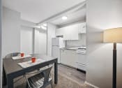 Thumbnail 20 of 37 - a kitchen and dining room with white appliances and a table and chairs