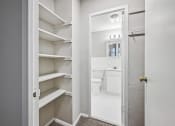 Thumbnail 29 of 37 - a small bathroom with white cabinets and a door to the toilet