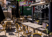 Thumbnail 16 of 22 - a patio with tables and chairs outside of a restaurant