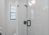 Thumbnail 14 of 22 - a white bathroom with a glass shower door