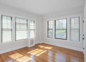 Thumbnail 4 of 22 - a living room with wood floors and windows