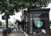 Thumbnail 15 of 16 - a coffee shop on a sidewalk next to a tree
