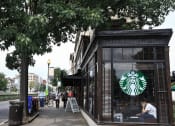 Thumbnail 22 of 22 - a coffee shop on a sidewalk next to a tree