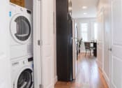 Thumbnail 11 of 20 - a small laundry room with a washing machine and a dryer