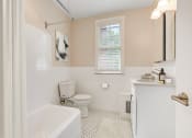 Thumbnail 10 of 22 - a bathroom with a toilet and a tub and a sink