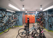 Thumbnail 16 of 41 - a room with many bikes on the wall and a wall of orange boxes