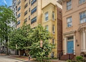 Thumbnail 20 of 20 - an apartment building with a blue door on a street