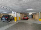 Thumbnail 4 of 37 - a parking garage with cars in it