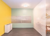 Thumbnail 6 of 37 - a living room with yellow and white walls and a white room divider