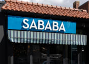 Thumbnail 28 of 35 - the front of a restaurant with a blue sign that reads sabba