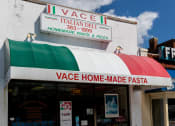 Thumbnail 29 of 35 - the front of a pizza restaurant with a rainbow awning