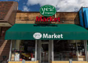 Thumbnail 32 of 34 - the front of a yes market store with a green awning