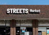 Thumbnail 33 of 34 - a streets market sign on the front of a brick building
