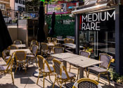 Thumbnail 23 of 35 - a patio with tables and chairs outside of a restaurant