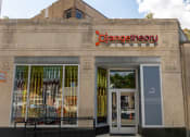 Thumbnail 30 of 34 - the front of a store with a sign on the side of a building