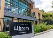 Thumbnail 19 of 35 - a sign in front of a building with a library