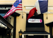 Thumbnail 20 of 20 - a flag and a sign on the side of a building