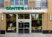 Thumbnail 18 of 20 - the front of a converse bike shop with a sign above the door
