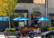 Thumbnail 26 of 34 - a motorcycle parked in front of a dukes counter on a city street