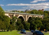 Thumbnail 41 of 41 - a bridge over a road with cars driving under it