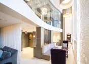 Thumbnail 8 of 41 - the lobby of a building with purple chairs and a reception desk