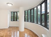 Thumbnail 18 of 18 - an empty living room with large windows and wood flooring