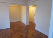 Thumbnail 9 of 28 - A room with a wooden floor and a door.