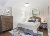 Thumbnail 11 of 35 - bedroom with a bed and a dresser and two windows