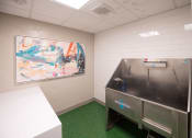 Thumbnail 14 of 41 - a small room with a refrigerator and a painting on the wall